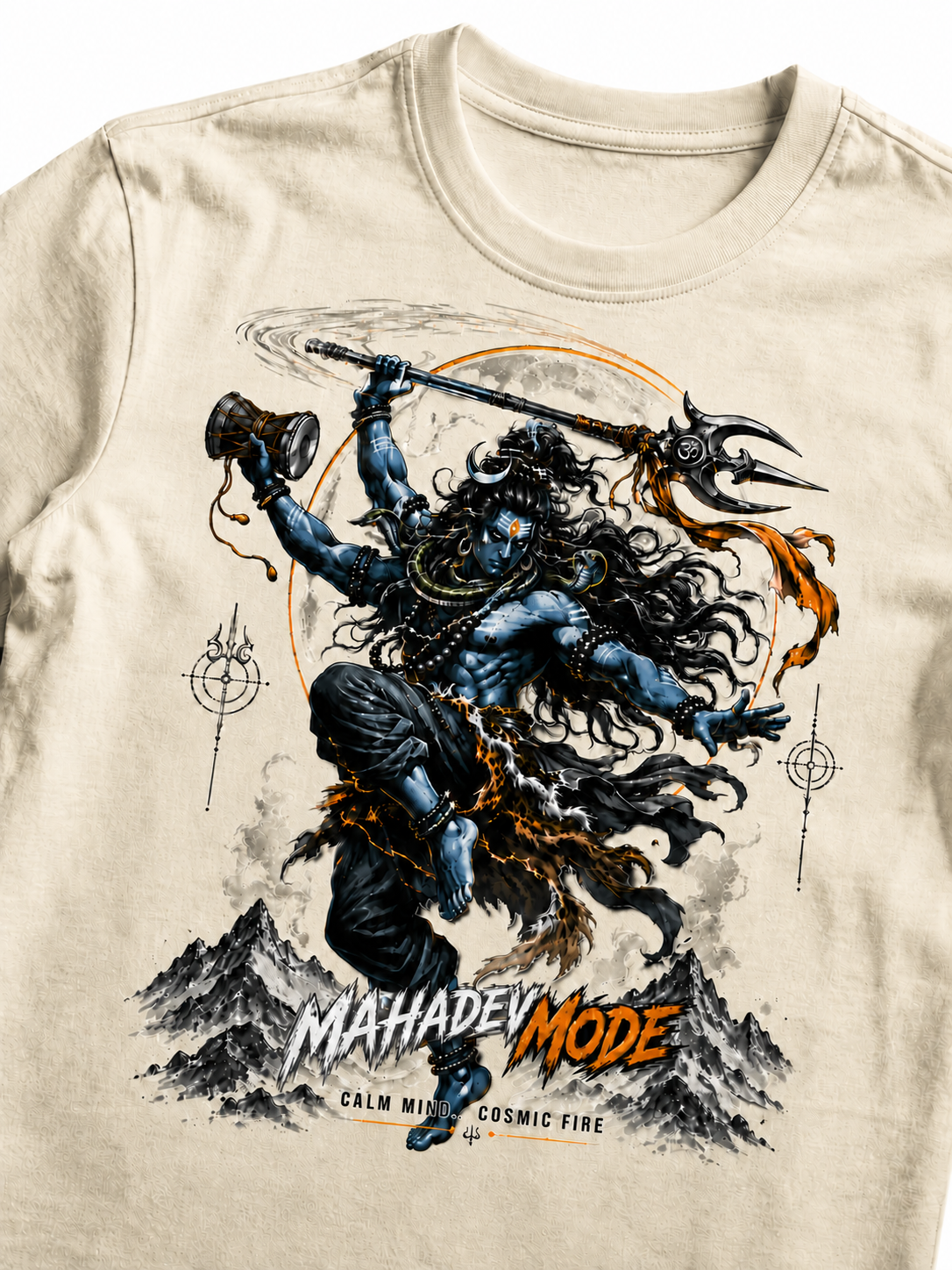A close-up of a beige crewneck t-shirt featuring a detailed graphic print of the Hindu deity Shiva in a dynamic pose, holding a trident and mace, with the text 'MAHADEV MODE' printed below.
