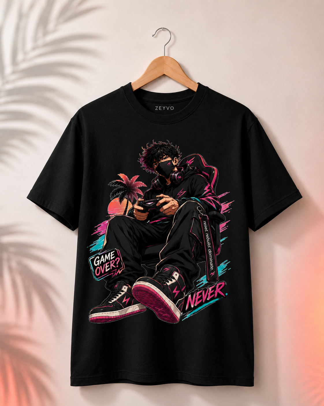 A black short-sleeve graphic t-shirt hanging on a wooden hanger against a light beige wall with soft palm leaf shadows. The shirt features a large colorful graphic of a person gaming, with neon pink, purple, and blue accents, and the text 'GAME OVER' and 'NEVER'.