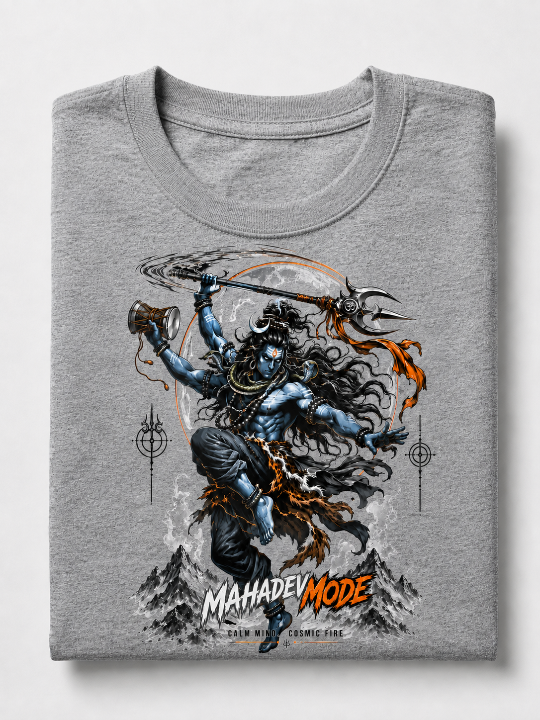 A folded heather gray t-shirt featuring a detailed graphic print of Lord Shiva in blue and black with orange accents, set against a light gray background.